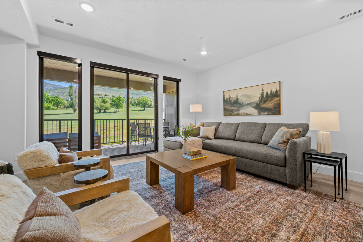 Bright and inviting living room with comfortable seating and mountain views.