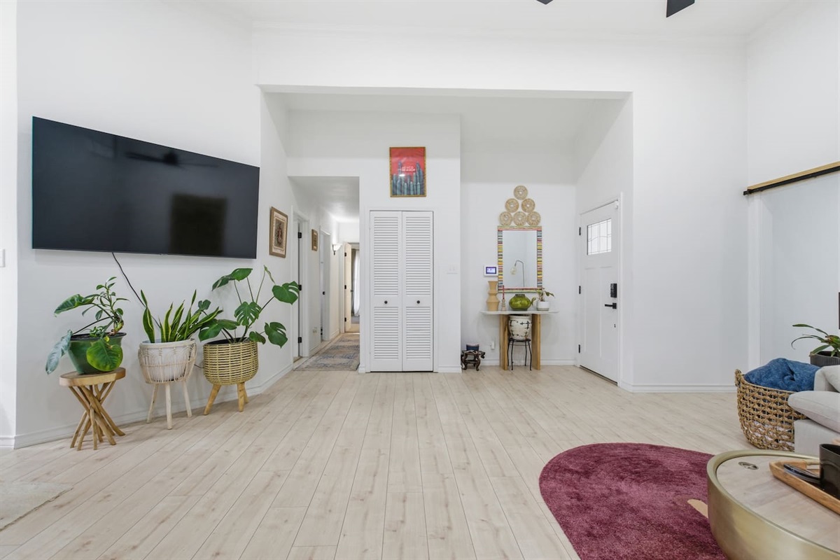 Airy living room with Smart TV, high ceilings, soft sectional sofa, fast WiFi, and open layout perfect for entertaining or unwinding after exploring Dallas.