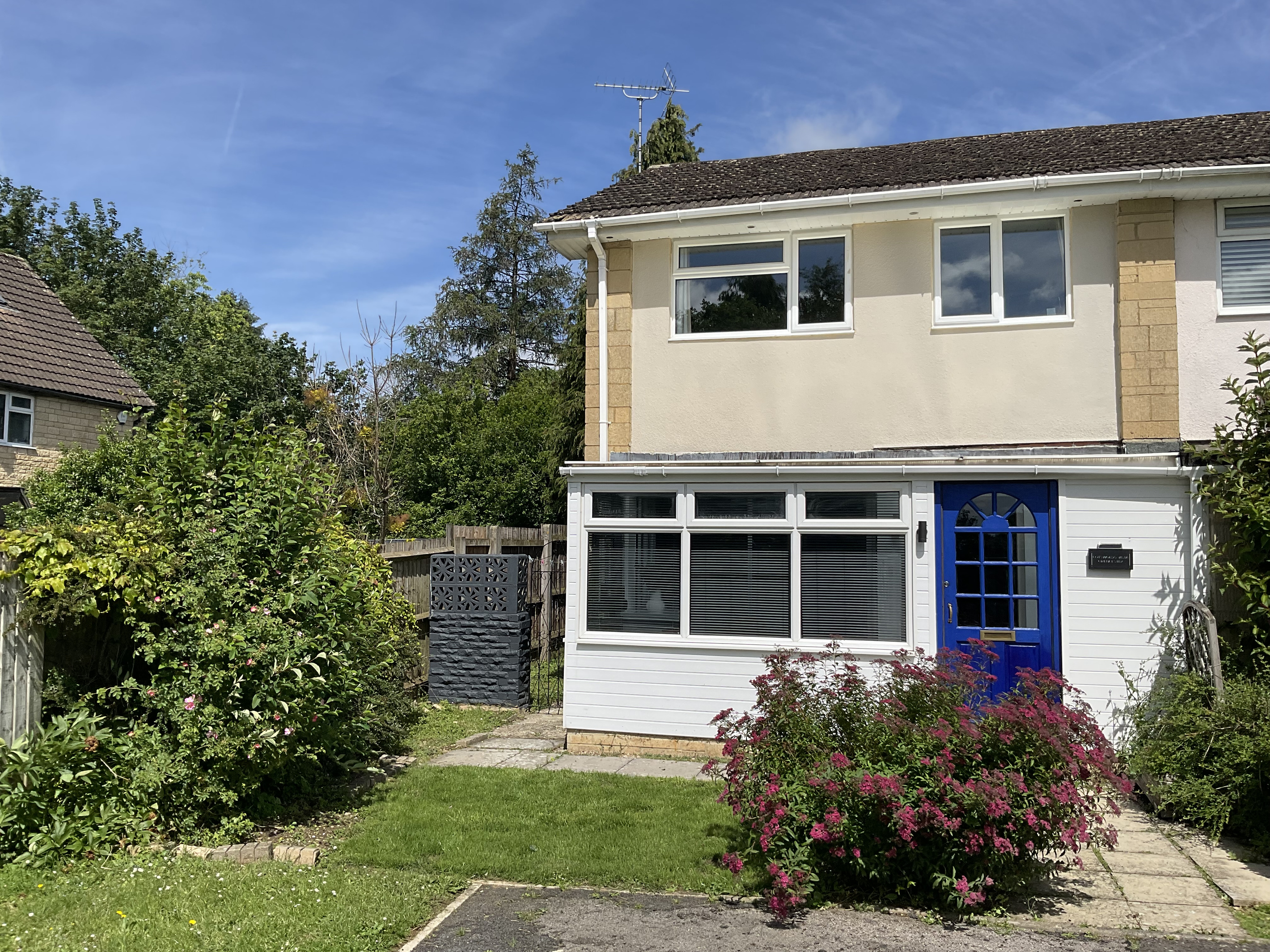 The front of the house fronts onto a green