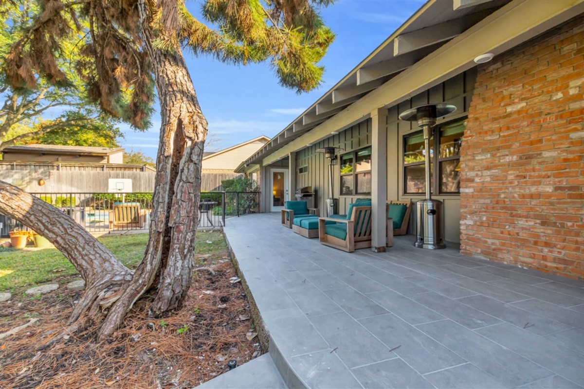 Spacious private backyard with comfortable outdoor seating and propane heaters, perfect for relaxing evenings, social gatherings, and enjoying the outdoors year-round.