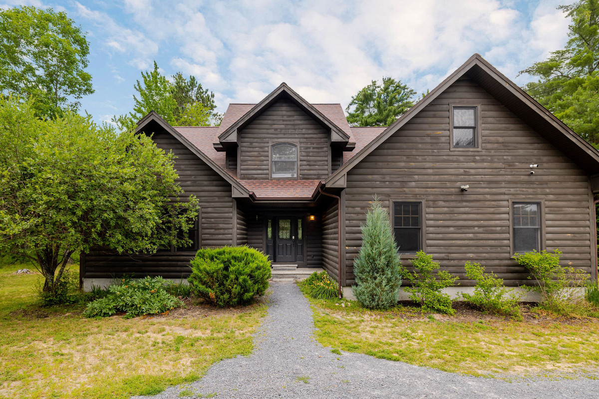 Welcome to your private Adirondack retreat—a beautiful log-style home nestled among the trees, just minutes from Whiteface Mountain and Lake Placid.