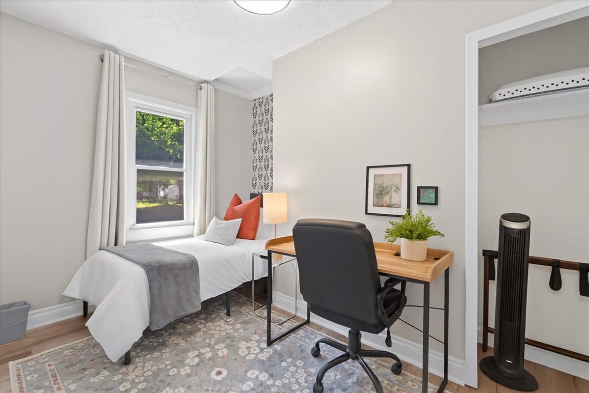 Cozy bedroom with twin bed and functional desk