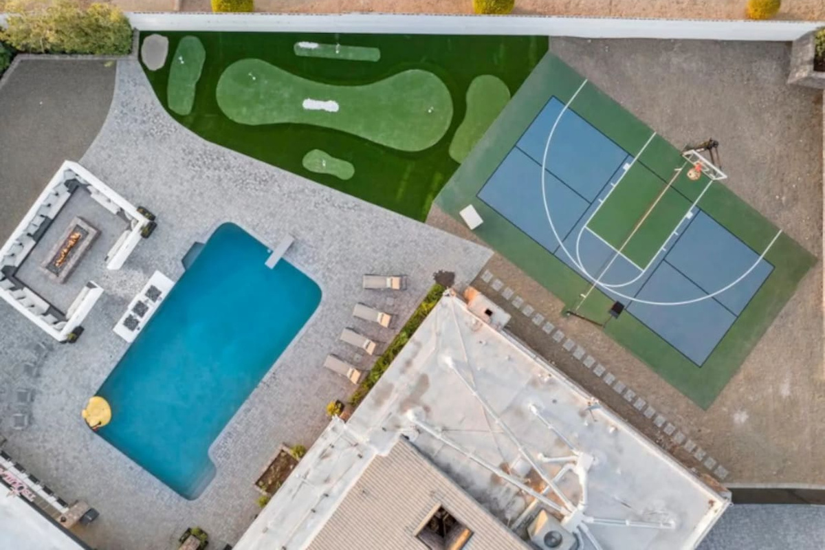 From above: pool, putting green, and sport court all connect in one backyard layout.