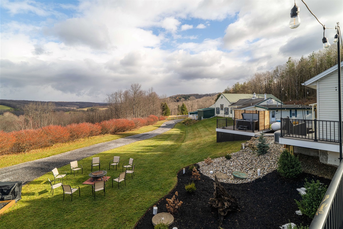 Expansive backyard with fire pit, mountain views, and wide-open skies.