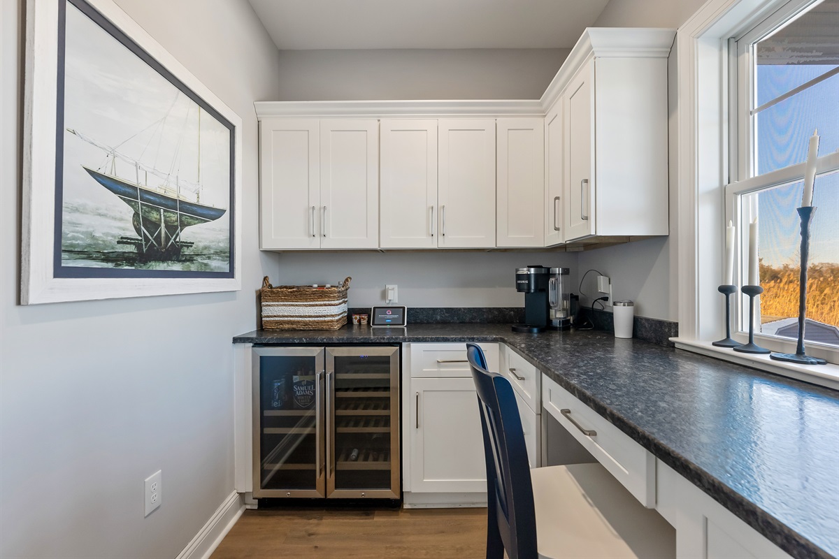 Dedicated Office Space With Coffee Maker and Additional Beverage Fridge Overlooking Pool