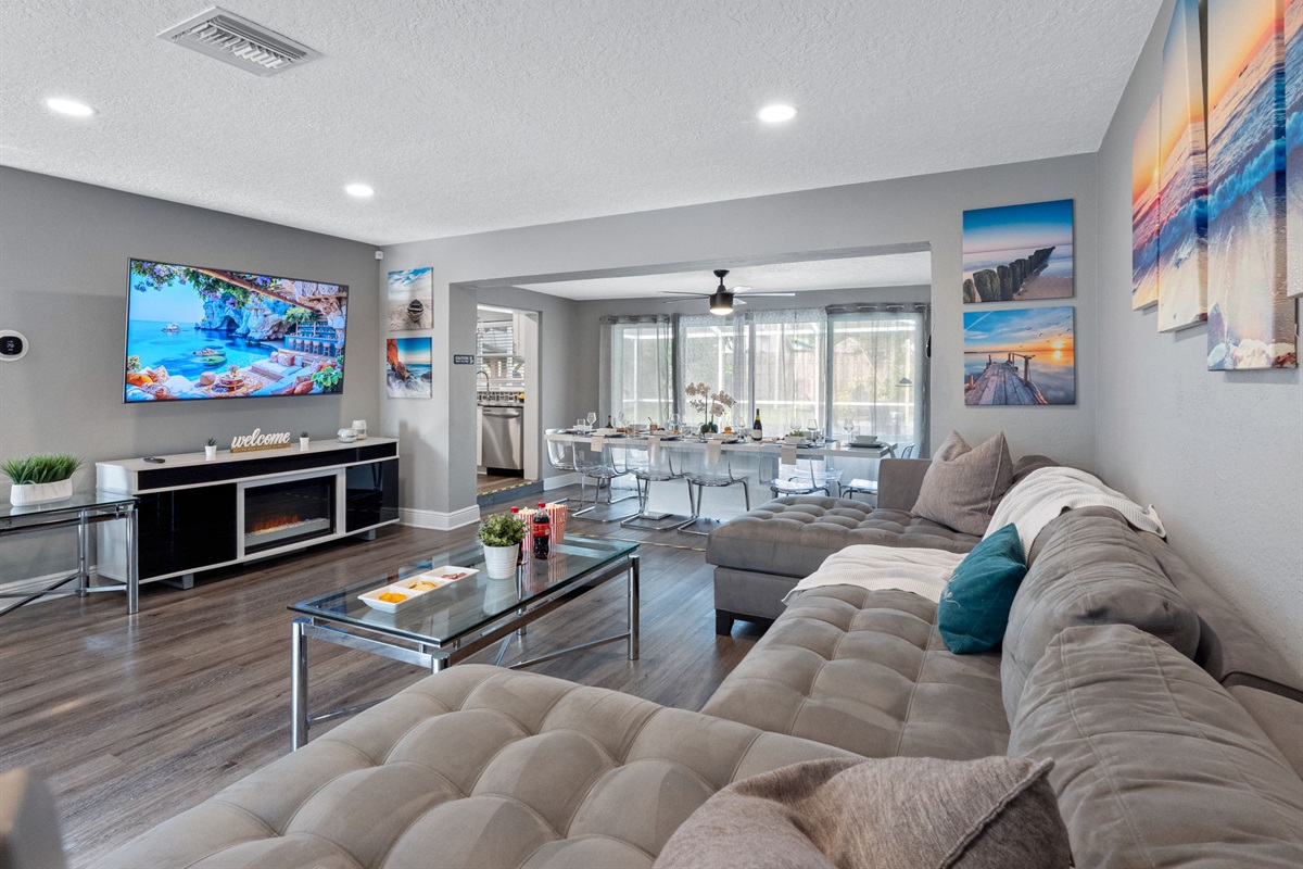 With its oversized sectional, calming coastal artwork, and a massage chair tucked in the corner, this living room is built for serious relaxation.
