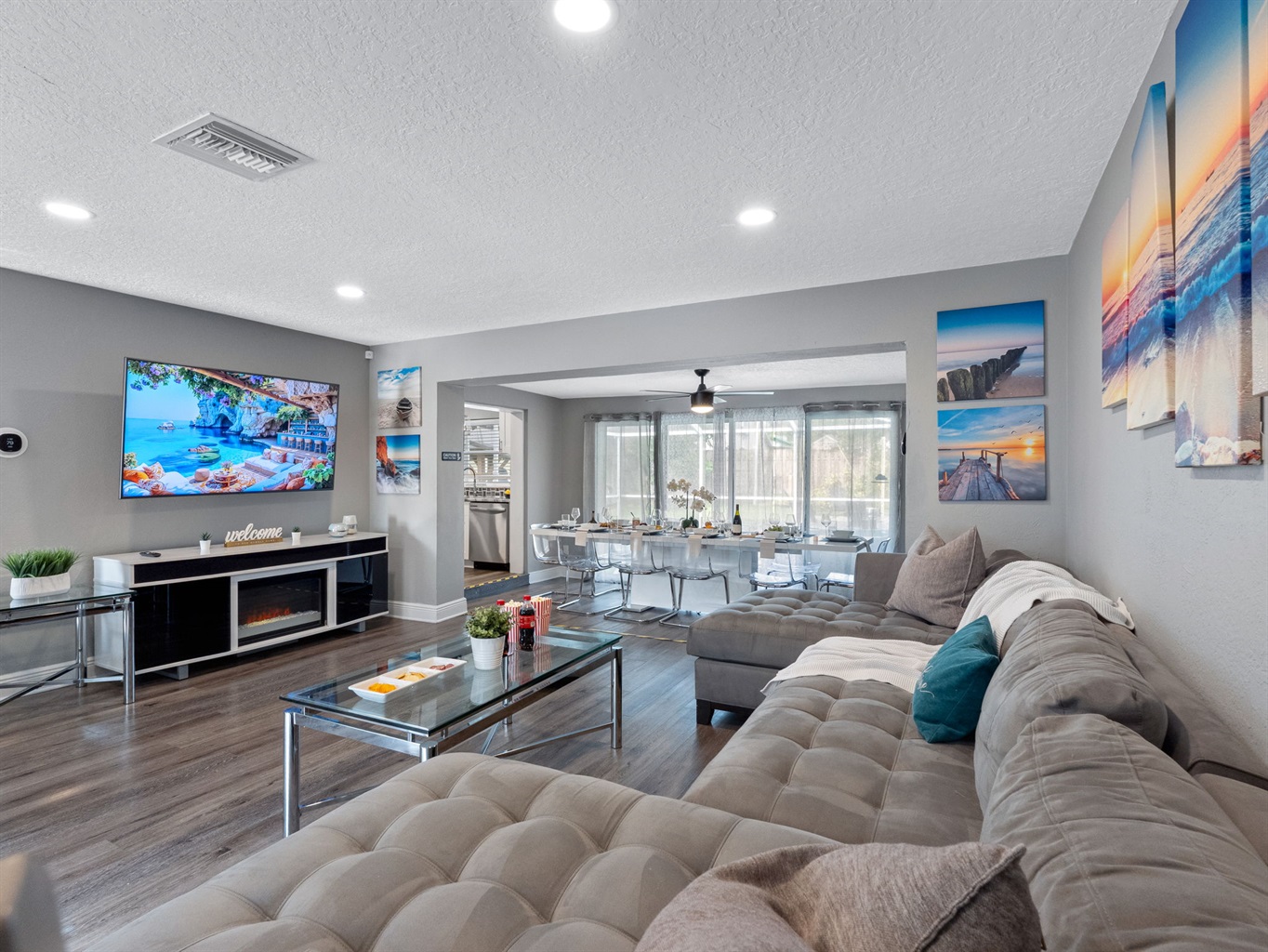 With its oversized sectional, calming coastal artwork, and a massage chair tucked in the corner, this living room is built for serious relaxation.