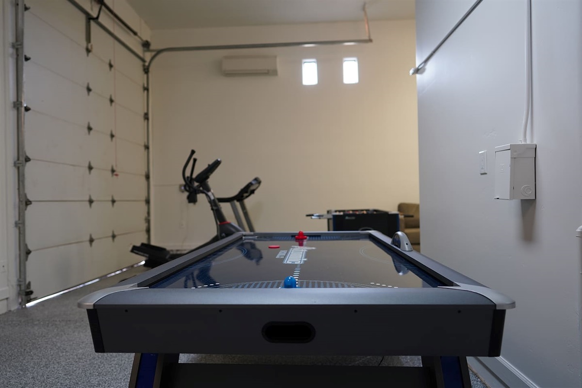 Air conditioned and heated garage space includes tons of games like foosball, air hockey, and shuffleboard.