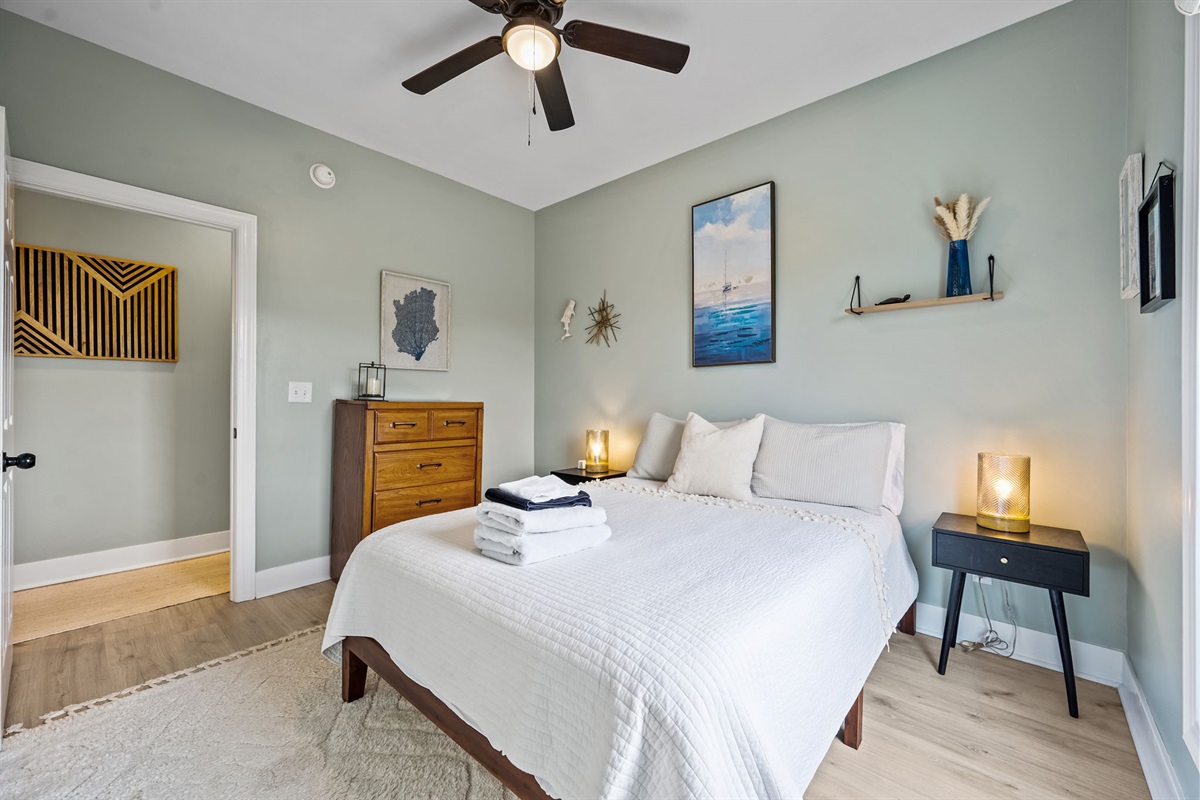 Queen Bedroom 2: a calming retreat with stylish coastal d&eacute;cor, a comfortable queen bed, and soft natural lighting