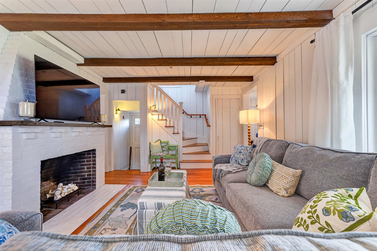 Cozy living room featuring a TV and fireplace, creating a warm and comfortable space for relaxing or movie nights.