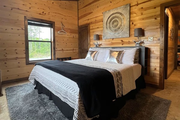 King bedroom with warm wood finishes.