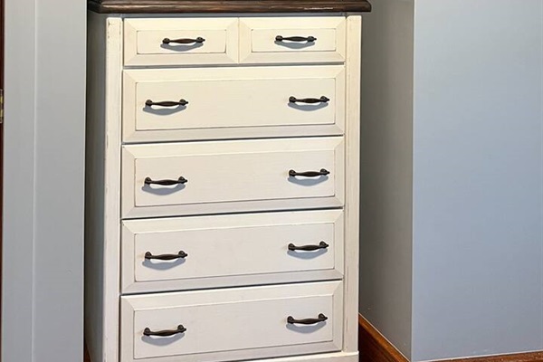 Stylish bedroom featuring a modern cabinet and a widescreen TV mounted on a sleek countertop—designed for contemporary comfort and functionality, offering a perfect balance of elegance and relaxation in a cozy space