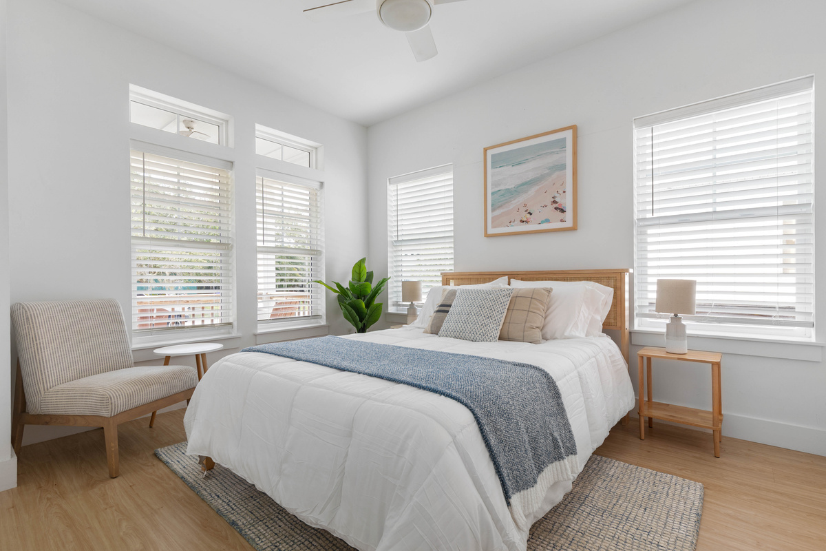 Light comes in from three sides in this one. A cane headboard, a chair by the window for the reader in the family, and a bed made up soft enough that afternoon naps happen whether they were planned or not.