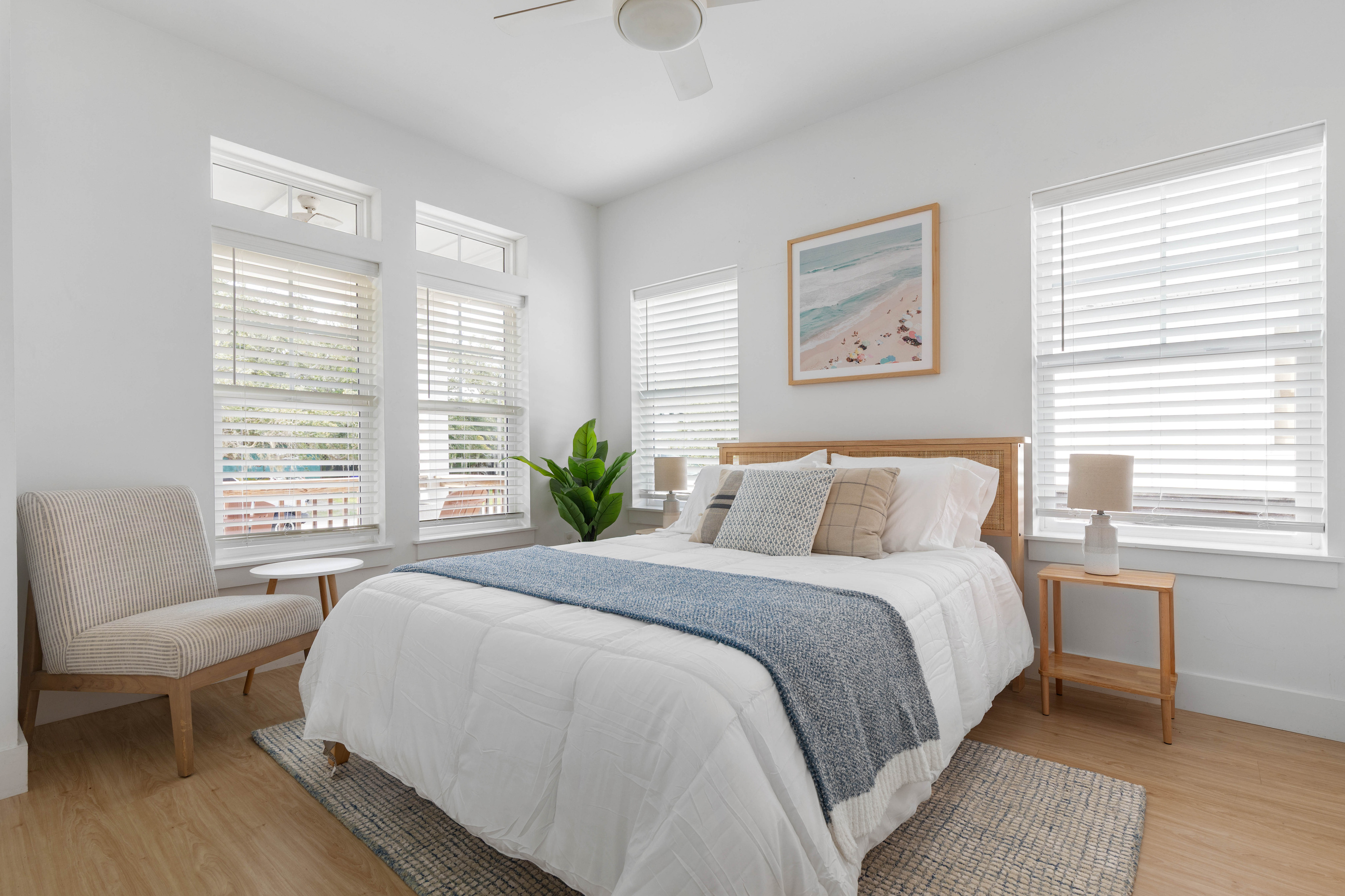 Light comes in from three sides in this one. A cane headboard, a chair by the window for the reader in the family, and a bed made up soft enough that afternoon naps happen whether they were planned or not.