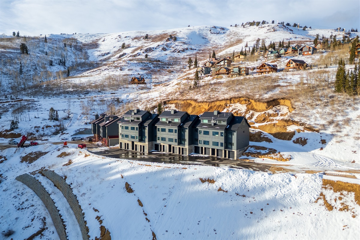 Drone view highlighting ski access and mountain setting.