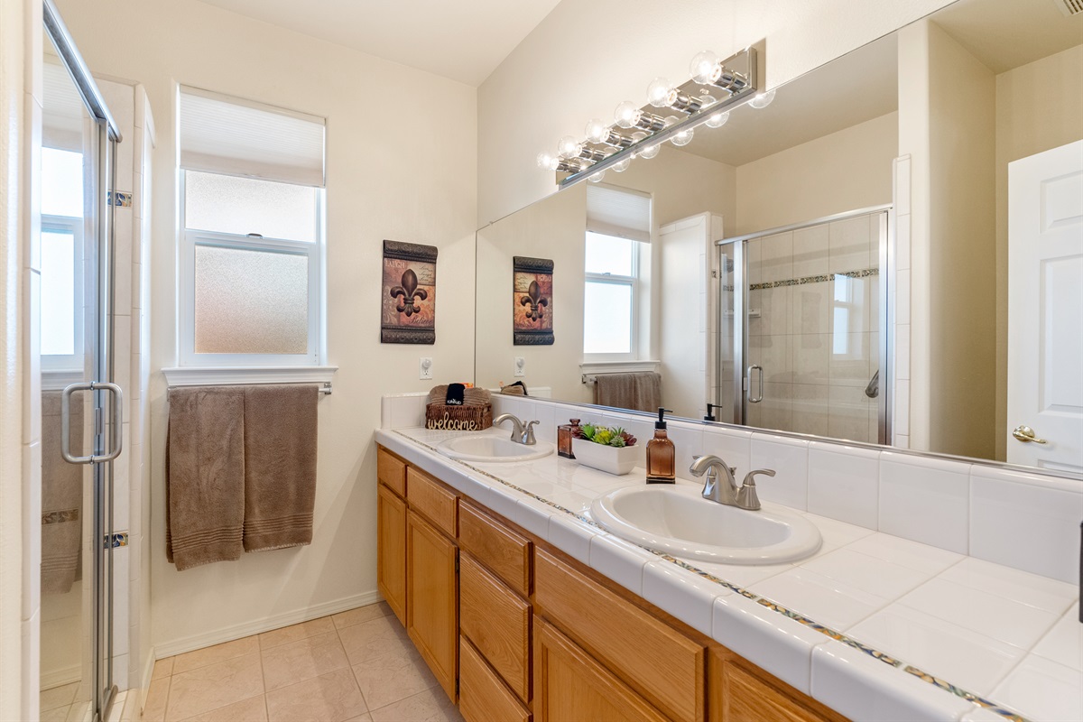 Spacious hall bathroom with plenty of counter space and shower.