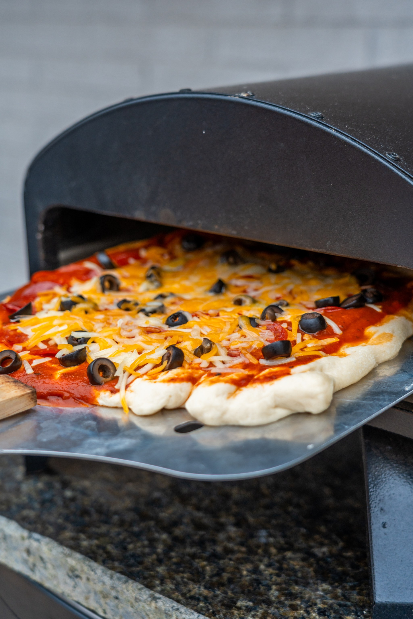 Watch the cheese bubble and pull it at exactly the right second — the pizza oven turns dinner into the evening's entertainment.