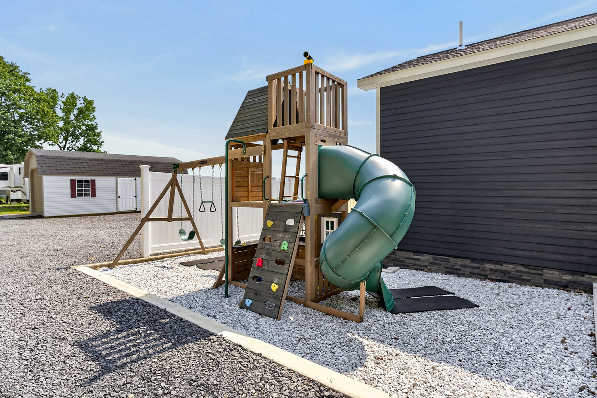 Play structure with slide and climbing wall
