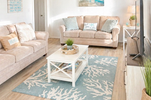 A cozy living room featuring a large smart TV, a collection of books, and plenty of games.