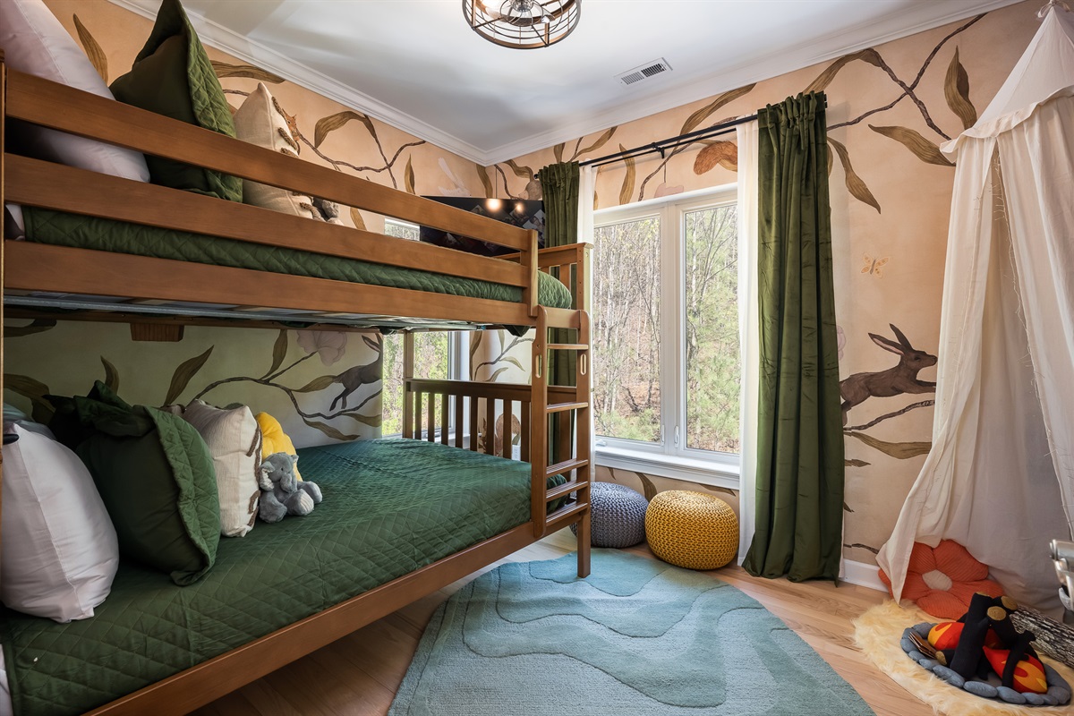 Bunk room with custom wood framing and playful design - perfect for kids or shared sleeping