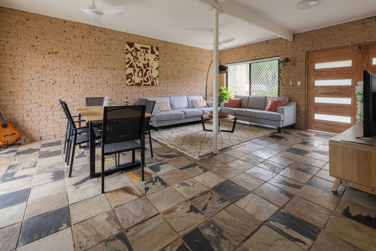 The lower-level space at Luna’s Sanctuary features lounge seating, dining, TV, entry access and kitchenette-style storage for easy indoor flexibility.