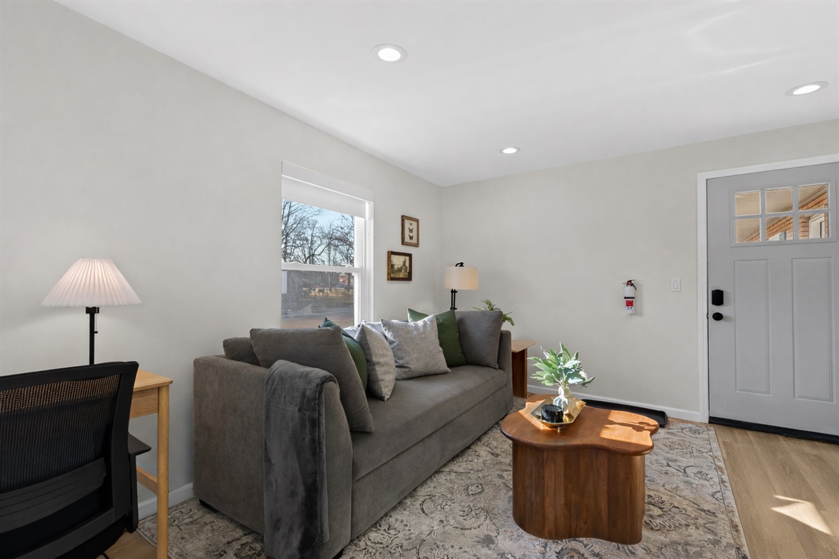 Comfortable living room with plush seating, soft natural light, and warm finishes—an inviting space to unwind or enjoy a cozy night in.