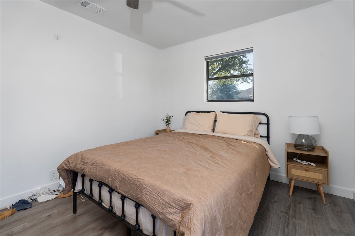 Cozy guest retreat with queen bed and natural lighting. Thoughtfully prepared with bed sheets, towels, and essentials for a comfortable home-away-from-home experience.