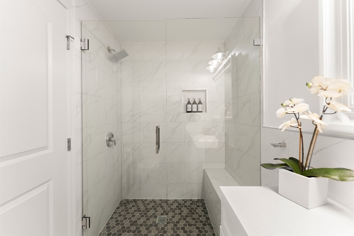 Downstairs bathroom with tiled shower.