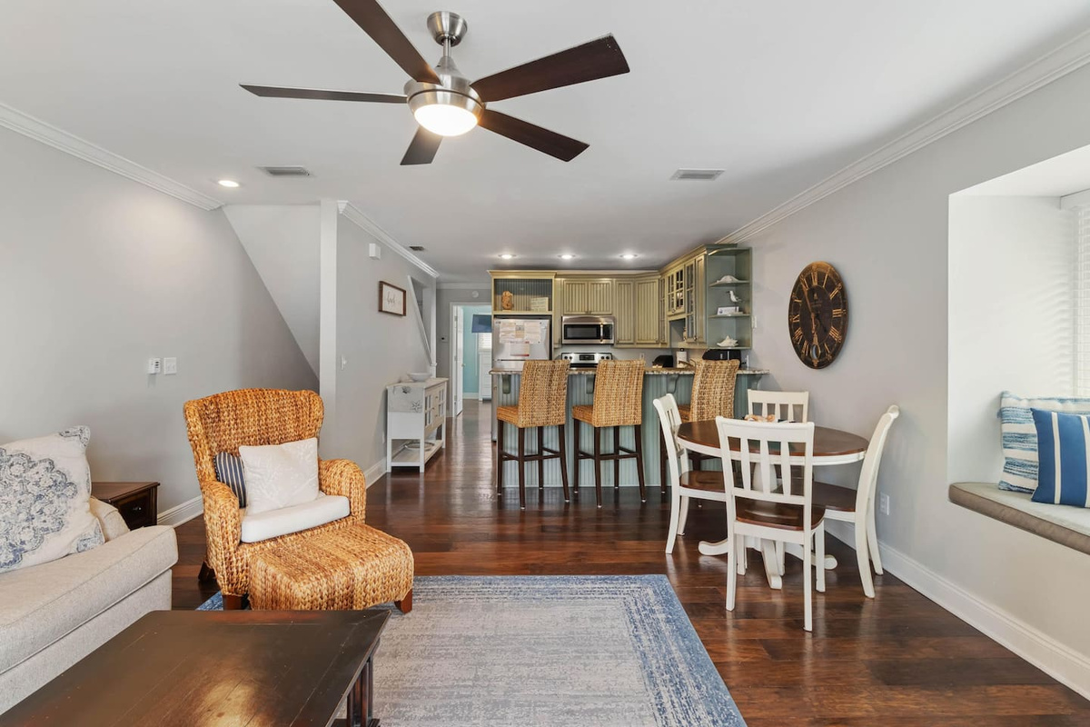 Come in from the beach, the living room is the first thing you see &mdash; wide open, light-filled, already set up for the afternoon.