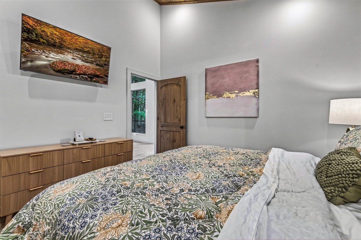 Master bedroom with king size bed and 55" smart tv 