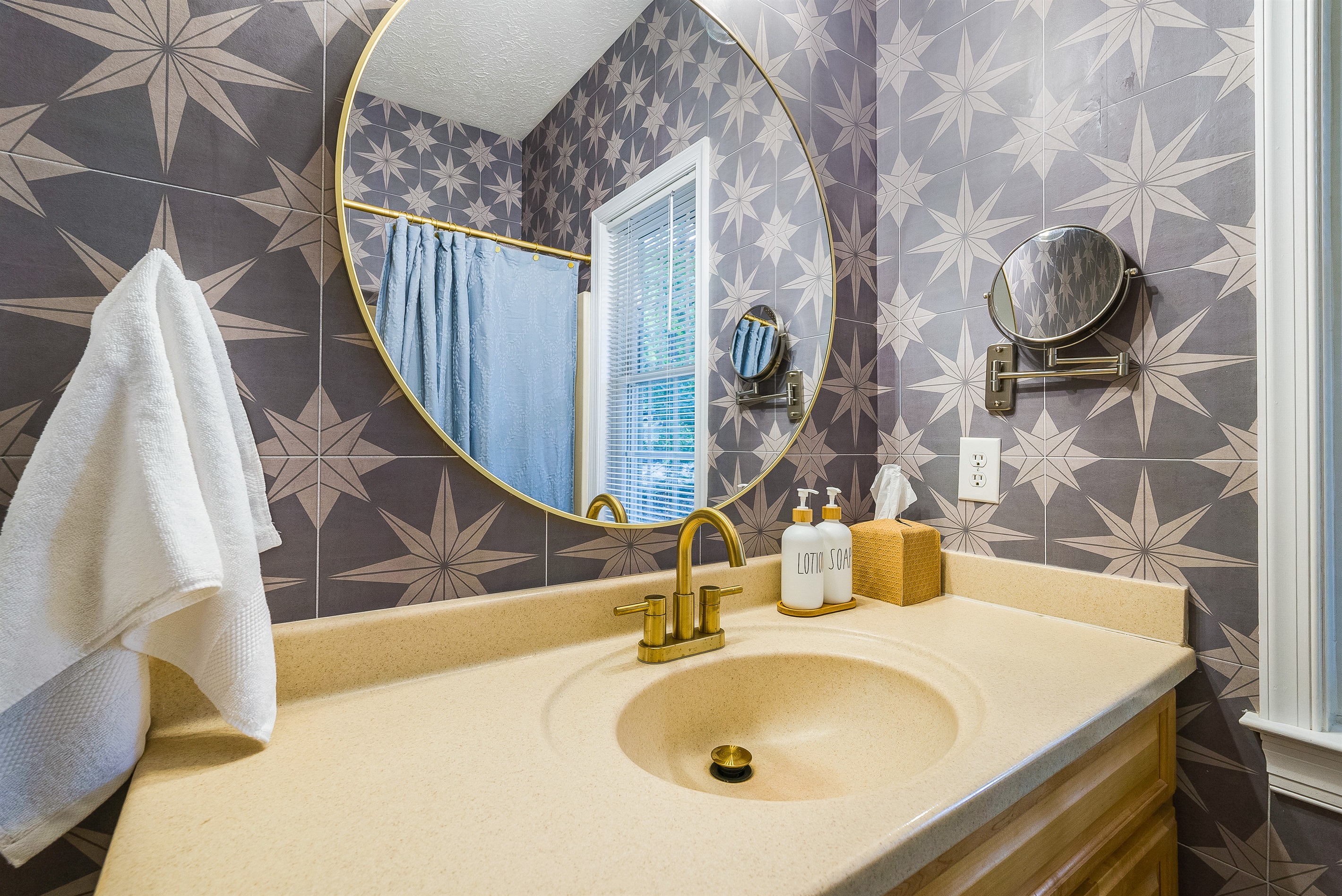 Thoughtful touches like spa-style soap, fluffy towels, and a large round mirror make freshening up easy and enjoyable.
