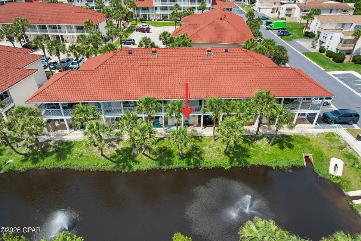 First-floor patio with peaceful lagoon views — perfect for morning coffee or evening unwinding. Quick, easy 2-minute stroll to beach access via sidewalk right out of your back door!