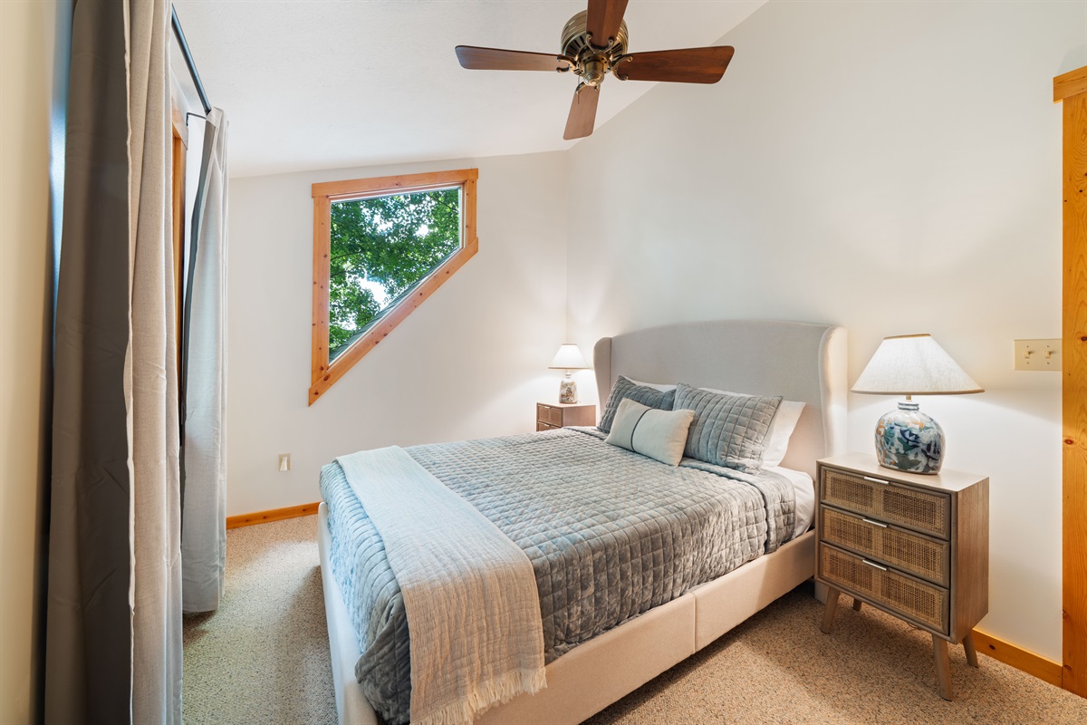 Relax in this upper-level bedroom with a new queen bed, memory foam mattress, and luxe bedding. Enjoy your views of the lake and the ceiling fan to help lull you to sleep.