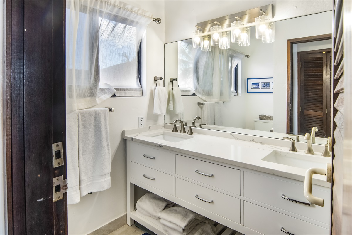 Beautifully updated en-suite bathroom with modern finishes and a clean, fresh feel.