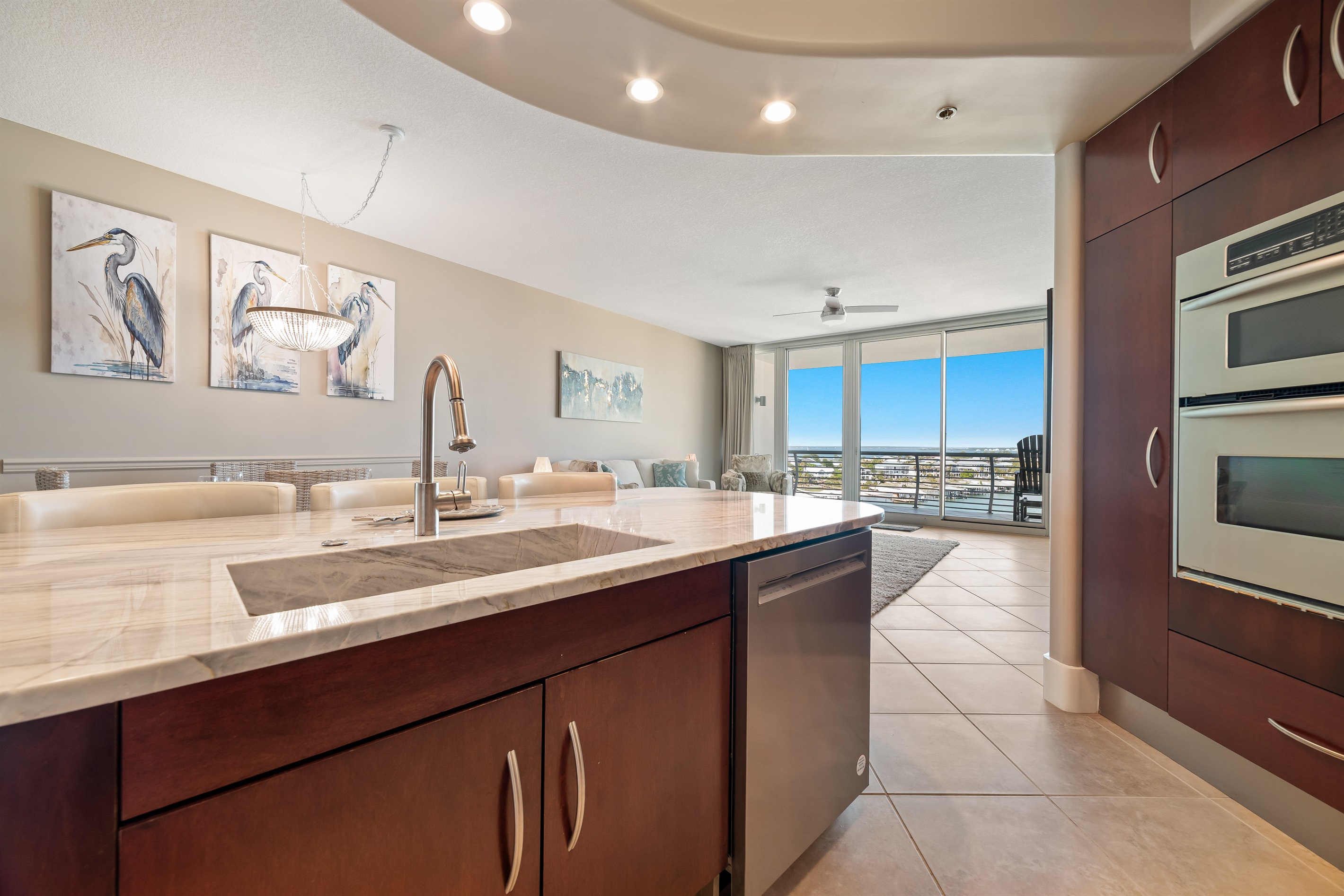 Designed for both intimate meals and grand entertaining, this space boasts ample natural light, high-end finishes, and striking floor-to-ceiling windows showcasing the impressive beach/city view.