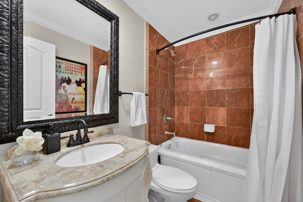 Bathroom 1, in hall outside of Bedroom 1, single vanity, shower/tub combo | Oceans 22 | 22 Beach Club Villas, Wild Dunes | IOP Escapes