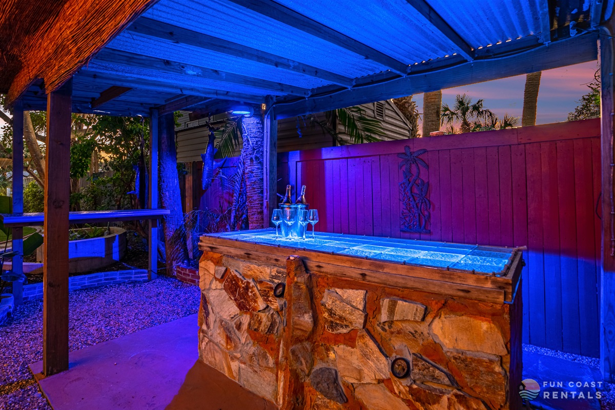 Private and inviting string lit zen Backyard with wood fire pit and bar!