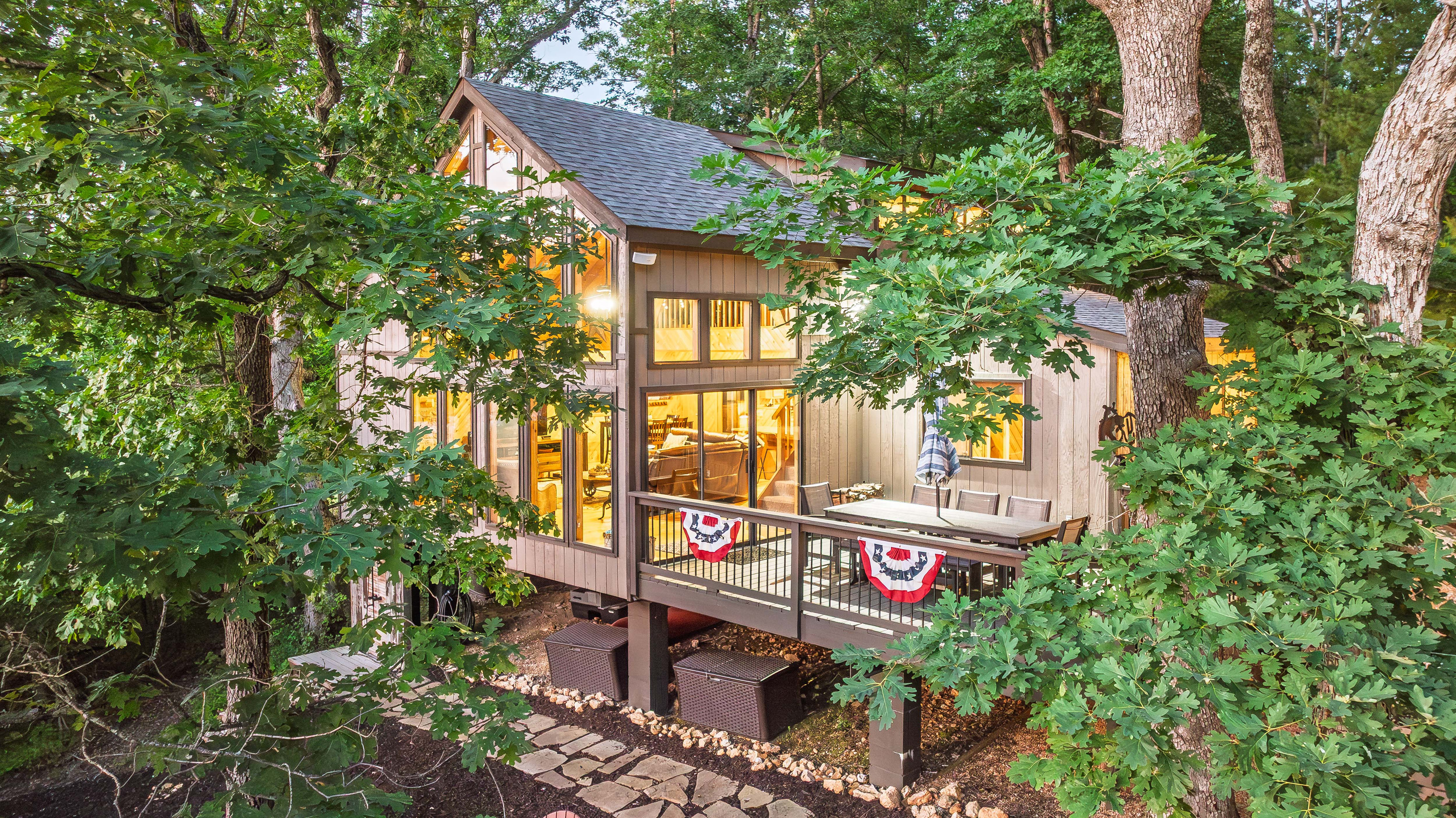 Longhorn Lakeside Chalet nestled along the lake with private beach, hot tub, kayaks, and fire pit.
