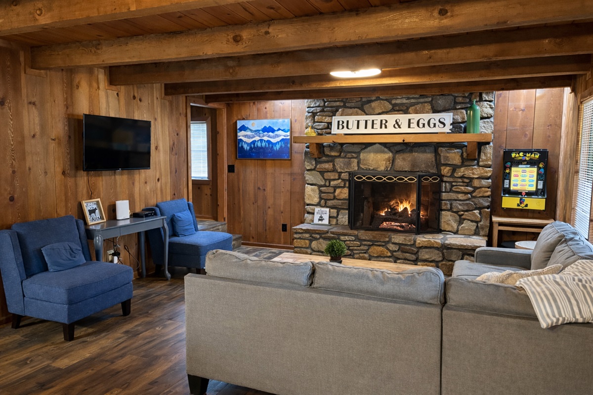 From fireside relaxation to retro arcade fun, this inviting living room is the heart of your mountain getaway.