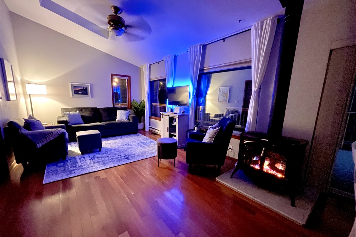 Living room in the evening. Propane lit  Fireplace for heat or ambiance and a back lit TV for ambiance. Perfect to relax and unwind