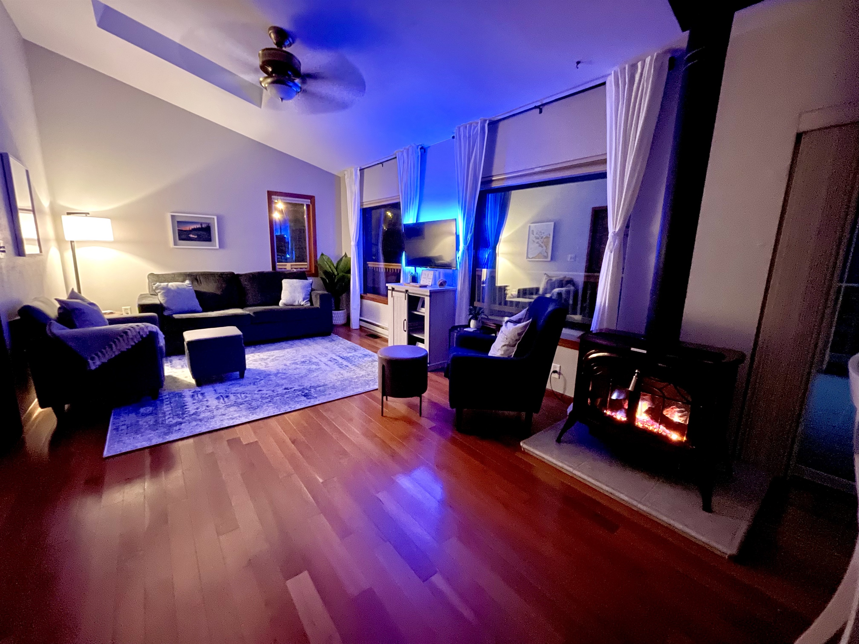 Living room in the evening. Propane lit  Fireplace for heat or ambiance and a back lit TV for ambiance. Perfect to relax and unwind