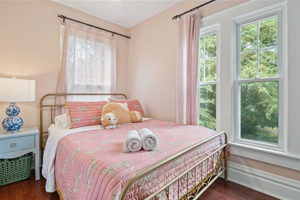 Bedroom 3 features an oversized closet, desk to work from, and a Queen Bed and overlooks the front street to the House.