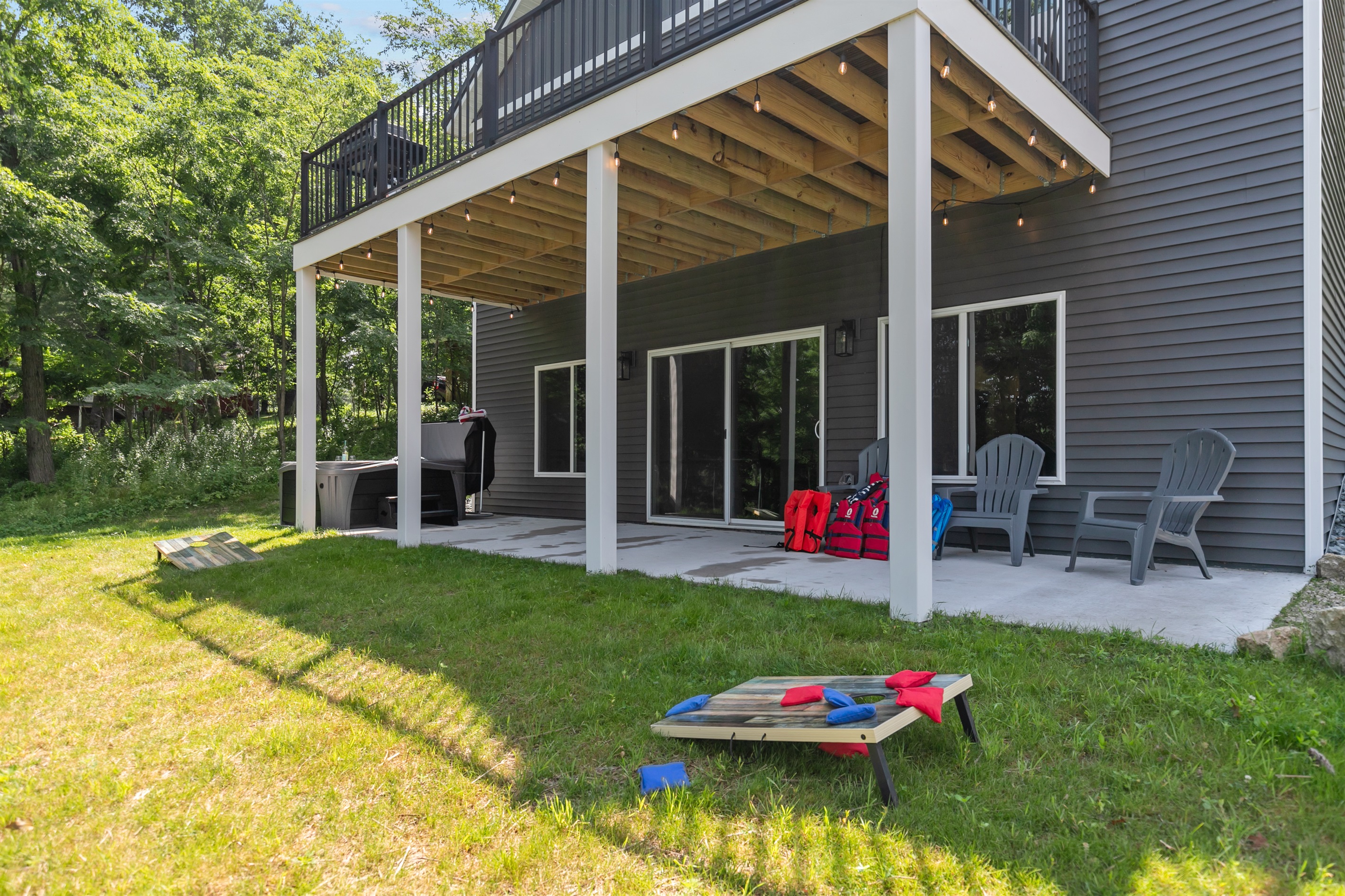 The spacious backyard is perfect for playing cornhole, relaxing with friends, or just soaking up the lake breeze
