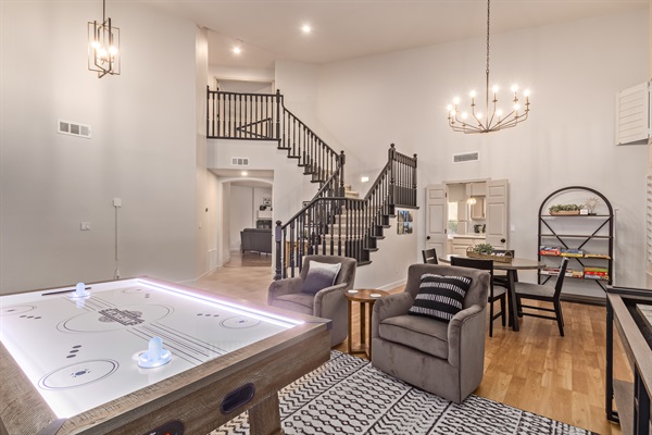 Front game room: Unwind with air hockey, shuffleboard, and a fun-filled board game collection!