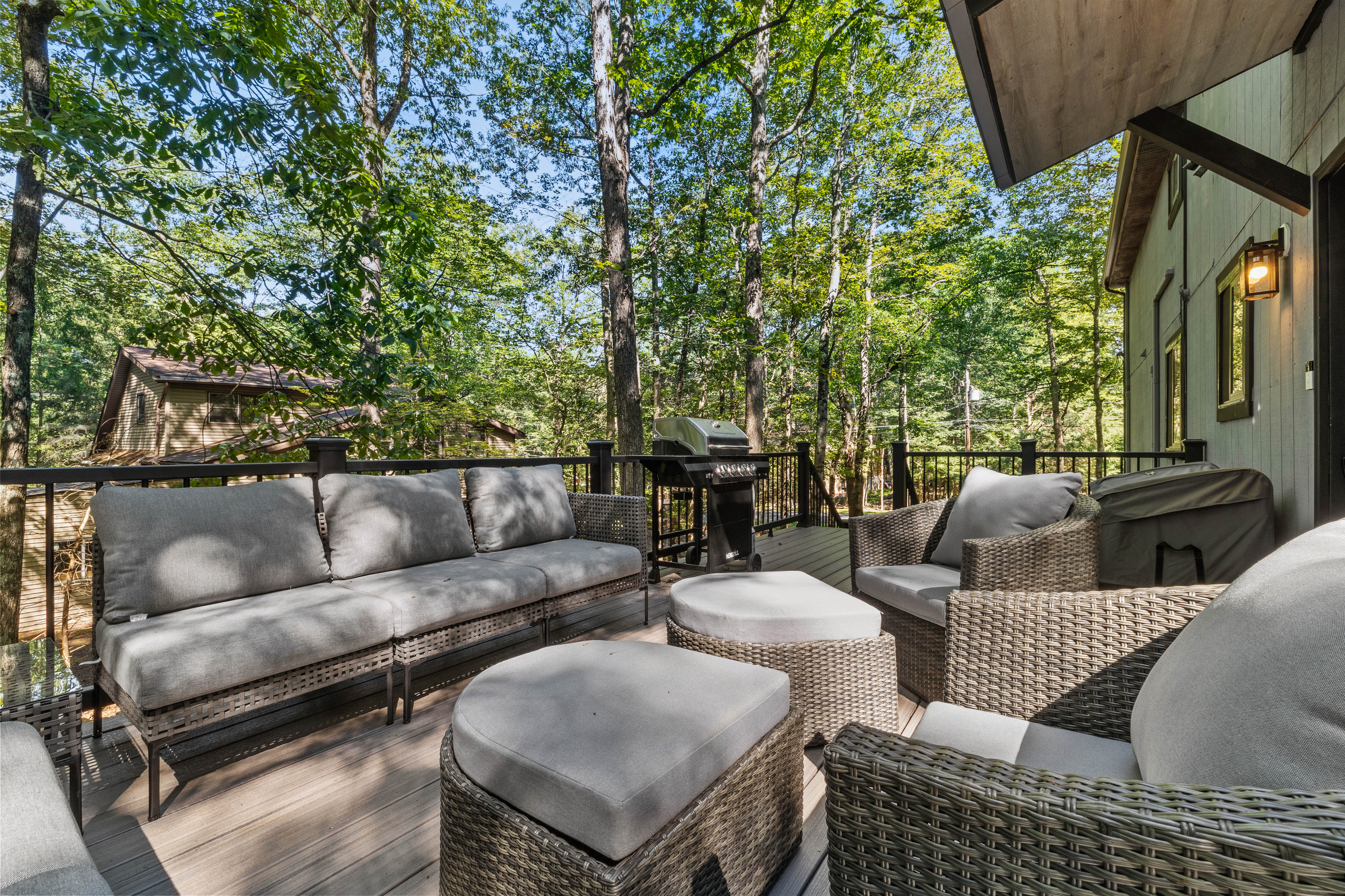 A spacious sectional and matching armchairs arranged for group conversation around a central table