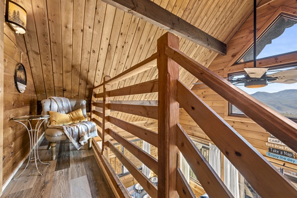A private nook is tucked away and perfect for cozying up with a book, kindle or laptop while enjoying the upper view. Or sneaking away to that private spot while still being a part of the entertainment from main floor below.
