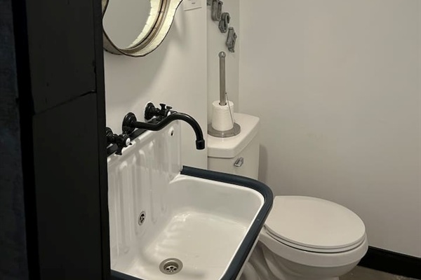 Retro sink, galvanized metal framed mirror, convenient to speakeasy and hot tub.