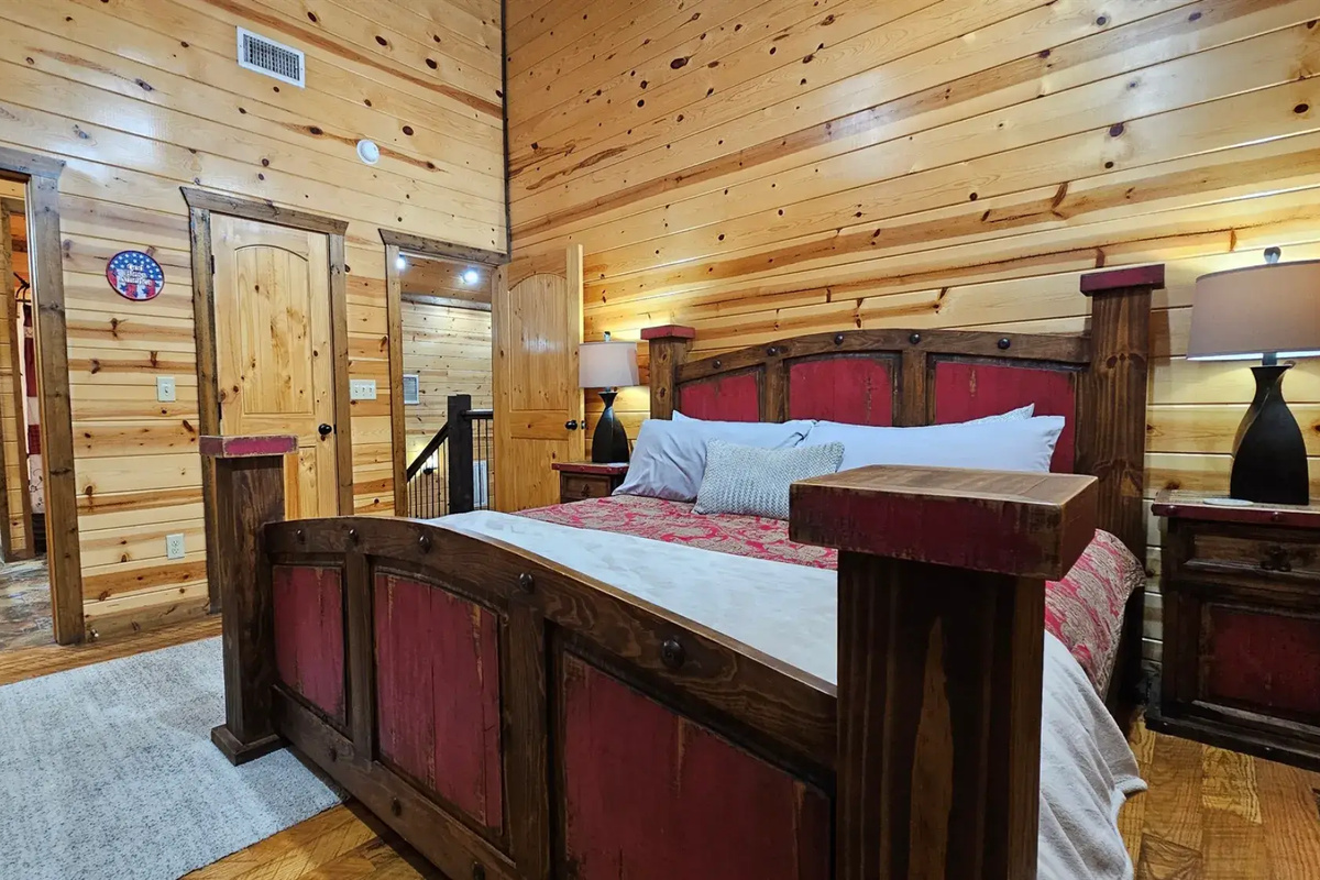 Bedroom 3: Rustic charm meets modern comfort with stunning wood accents and a serene view!