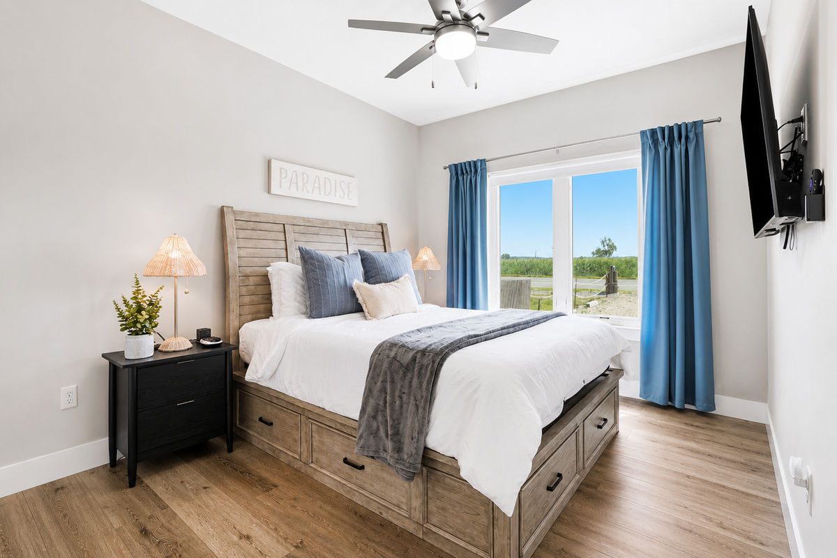 Rest easy in this inviting first-floor bedroom, featuring a plush queen bed, peaceful natural light, and everything you need for a comfortable and relaxing stay.