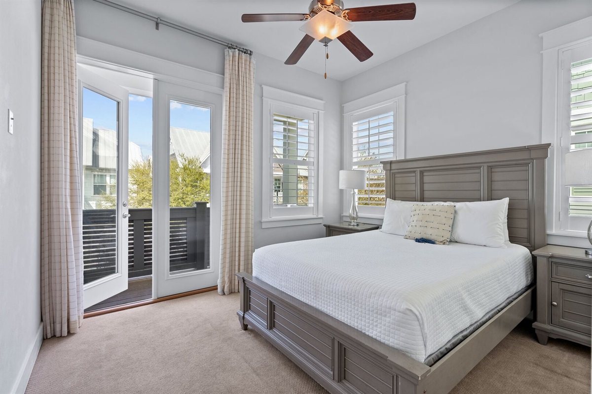 Primary bedroom with private balcony access.